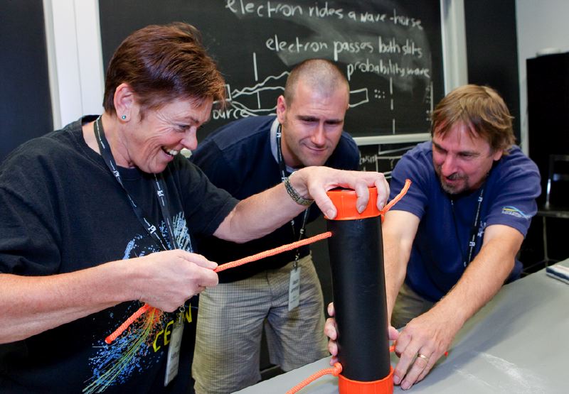 Three teachers conducting an experiment at Perimeter's EinsteinPlus workshop. 