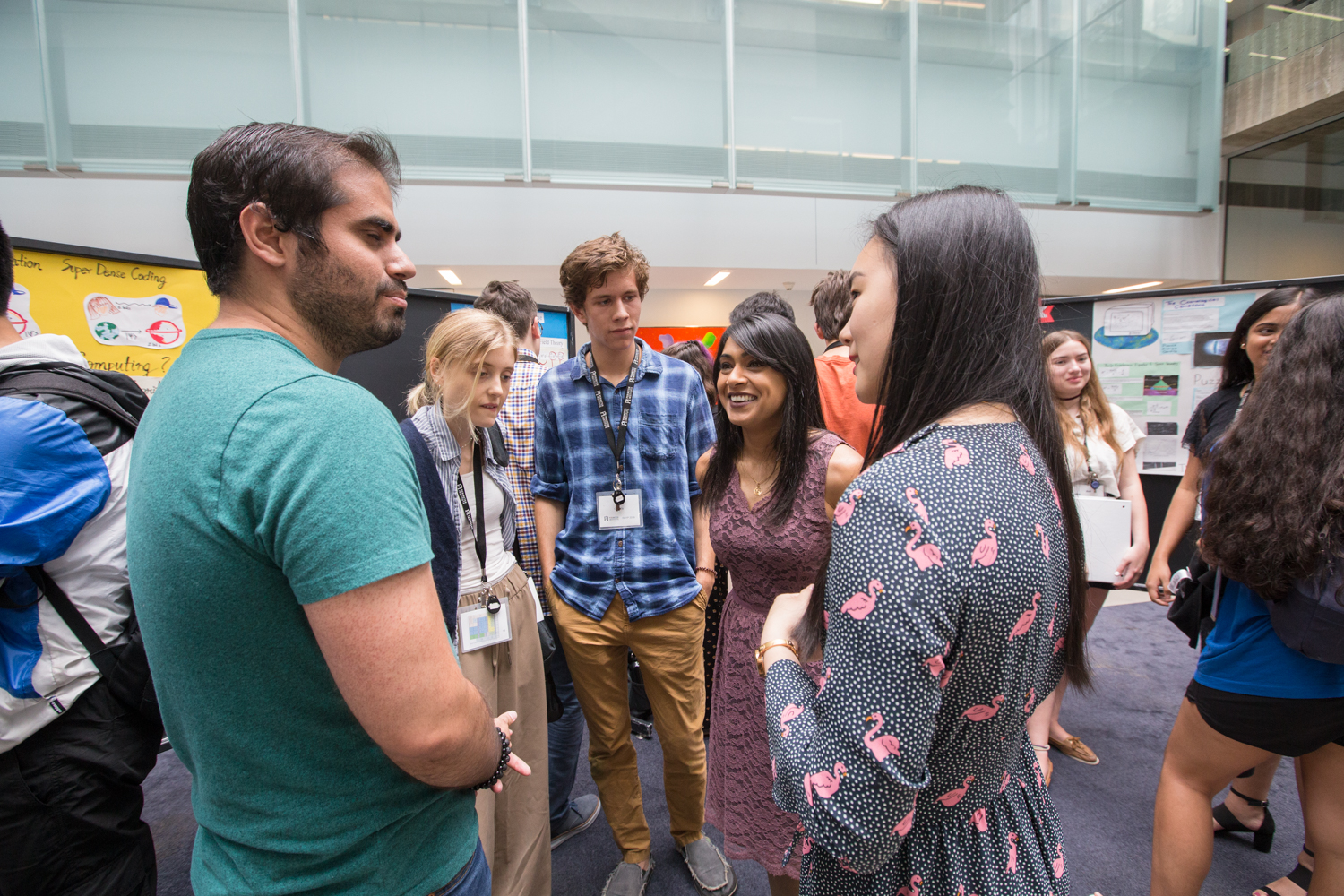 Taylor Walters and Benjamin Dobozy chatting with researchers and the Honourable Bardish Chagger, Member of Parliament for the riding of Waterloo and current Leader of the Government in the House of Commons.