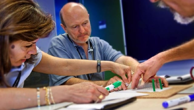 Three teachers working together on an experiment
